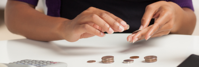 counting coins next to a calculator