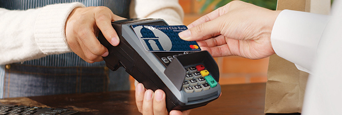 woman paying man for coffee using a chip reader
