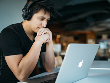 Young man looking at laptop