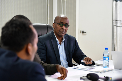 man in business meeting talking to other people image